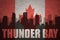 Abstract silhouette of the city with text Thunder Bay at the vintage canadian flag