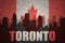Abstract silhouette of the city with text Toronto at the vintage canadian flag