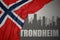 Abstract silhouette of the city with text Trondheim near waving national flag of norway on a gray background