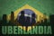 Abstract silhouette of the city with text Uberlandia at the vintage brazilian flag