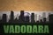 Abstract silhouette of the city with text Vadodara at the vintage indian flag