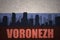 Abstract silhouette of the city with text Voronezh at the vintage russian flag