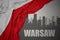 Abstract silhouette of the city with text Warsaw near waving national flag of poland on a gray background