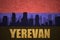 Abstract silhouette of the city with text Yerevan at the vintage armenian flag