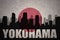 Abstract silhouette of the city with text Yokohama at the vintage japanese flag