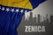 Abstract silhouette of the city with text Zenica near waving national flag of bosnia and herzegovina on a gray background