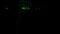 Abstract silhouette of male legs walking through the dark corridor with green glowing particles. Design. A man superhero