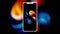 Abstract silhouette of a new new smartphone with blurred animation behind it on black background. Motion. Rotating