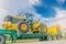 The abstract soft focus of the big tractor on the tow truck with the beautiful sky and cloud, by the beam, light, and lens flare e