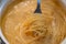 Abstract spaghetti background in boiling broth on fork close up