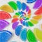 Abstract spiral fruit jelly rainbow wedges slices on white sugar sand background. Rainbow jelly candies. Sweet fruit jelly liths.