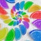 Abstract spiral fruit jelly rainbow wedges slices on white sugar sand background. Rainbow jelly candies. Sweet fruit jelly liths.