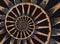 Abstract spiral wooden wagon cannon wheel black metal brackets rivets. Wheel wooden spokes fractal background. Horse vehicle wheel
