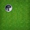 Abstract sport background of golf hole on green grass background.