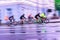 Abstract sport blurred violet background with bright colorful cyclists on the city street