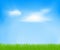 Abstract spring background with sky, clouds, green grass