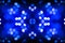Abstract symmetric glitter defocused blue lights bokeh texture on black background