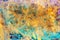 Abstract textural background with yellow, green and blue paint branch lines and splashes with divorces, furrows, inflows