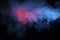 Abstract texture of backlit smoke in red blue on a black background