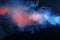 Abstract texture of backlit smoke in red blue on a black background