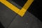 Abstract texture composition in the form of yellow boundary warning lines painted with paint on a dark gray background