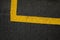 Abstract texture composition in the form of yellow boundary warning lines painted with paint on a dark gray background