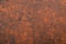 Abstract textured background of putty, painted in rusty-brown co