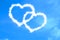 Abstract two hearts shape love draw on the blue sky with white clouds background, valentine day holiday event festive symbol sign