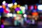 Abstract unfocused blurred background of night city lights illumination in darkness