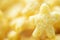 Abstract unfocused yellow background with macro of star-shaped corn flake. Close up image. Soft focus dreamy image. Banner with