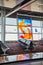 Abstract vibrant window art in empty airport terminal with seats