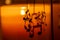 Abstract view of an interior candle lit shelf containing a spinning mobile with musical notes