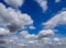 Abstract view of a leaning power utility pole seen against a dramatic summer sky.