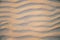 Abstract view of natural sand dune formation at the beach. Curly sand wave pattern closeup. Beautiful sandy background. Nobody