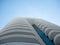 Abstract view on residential apartment complex building with many balconies and floors isolated against blue sky on sunny day