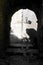 Abstract view of a texture wall with a street-lamp a seen from a dark, arched alleyway in the old citadel-town of Monemvasia,