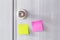 Abstract white door with metal doorknob is lock and sticker paper note on door. Text paper reminds the door for message