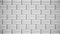 Abstract white rows of bricks fly into the sides on grey background, monochrome. Animation. White rectangle in many
