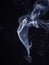 Abstract white smoke isolated on black background, close up view. Incense stick smouldering with white smoke, abstract