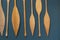 Abstract wood texture on a blue wall. Decorative oars hanging on a wall.