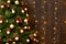 Abstract wooden background with christmas tree and lights, classic dark interior backdrop, copy space for text, winter holiday con