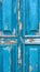 Abstract wooden background wooden door with cracks on the blue paint plaster