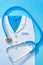 Abstract World Health Day concept with medical scrub and stethoscope on blue background.