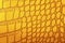 Abstract yellow alligator leather pattern for background. Skin of yellow reptile