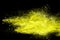 Abstract yellow dust explosion on black background