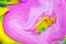 Abstract yellow multicolored background pink green yellow view macro paint acrylic underwater ultra drop blob drip plastic coral