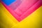 Abstract yellow, pink and blue coloured paper layers macro photo as colourful texture background