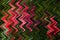 Abstract zig zag pattern with waves in red and green colors. Artistic image processing created by flowers photo.