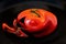 Abstraction of red tomatoes against a black background- This imagine can be used for backgrounds of desktops