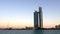 Abu Dhabi city beach at sunset | View of the Nation towers, a famous hotel, office and mall - landmarks on the corniche street